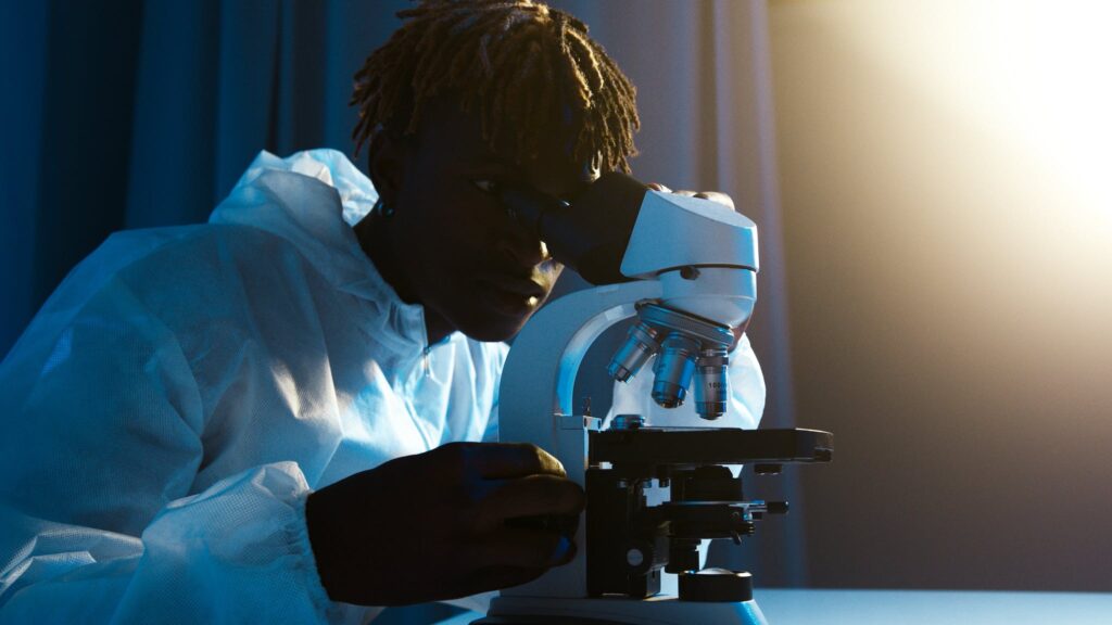 A science major student looking through the microscope