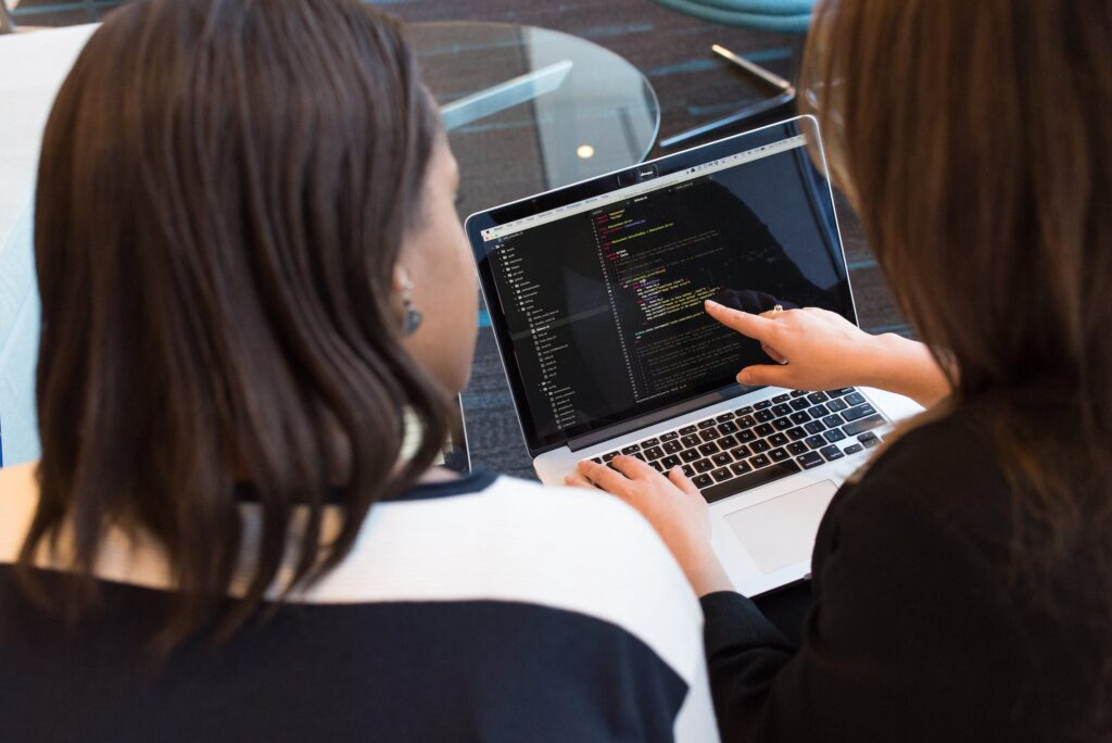 web developers studying codes on a laptop