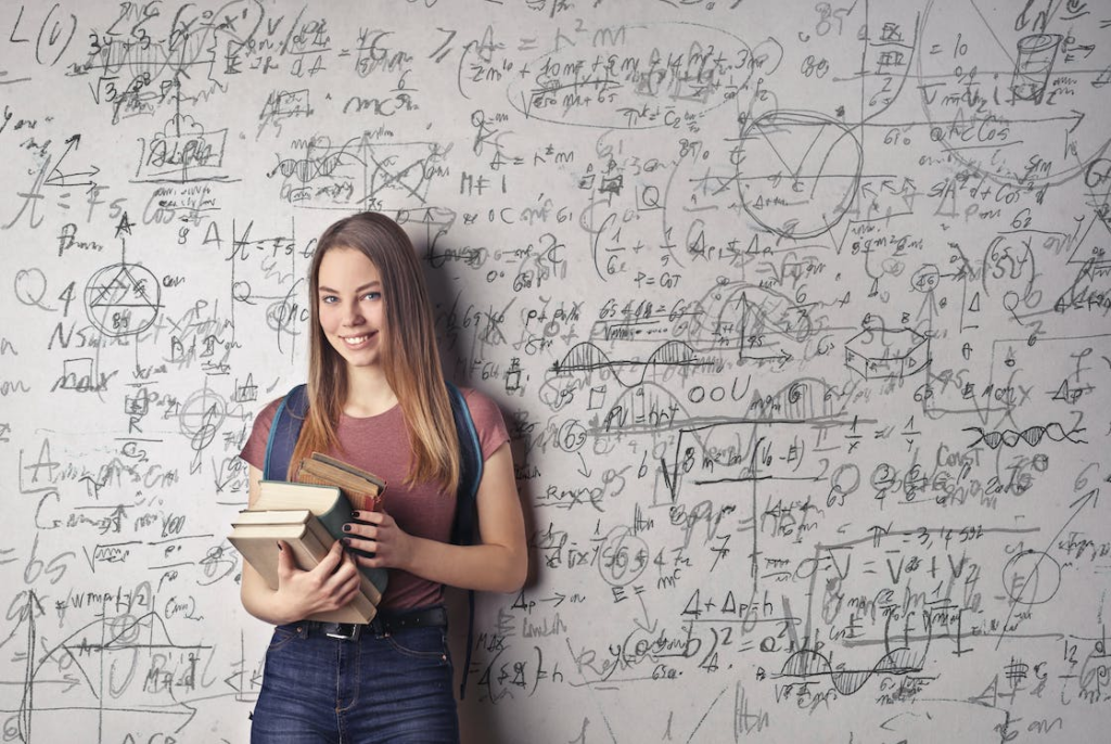 happy mathematics degree student with formulas as background