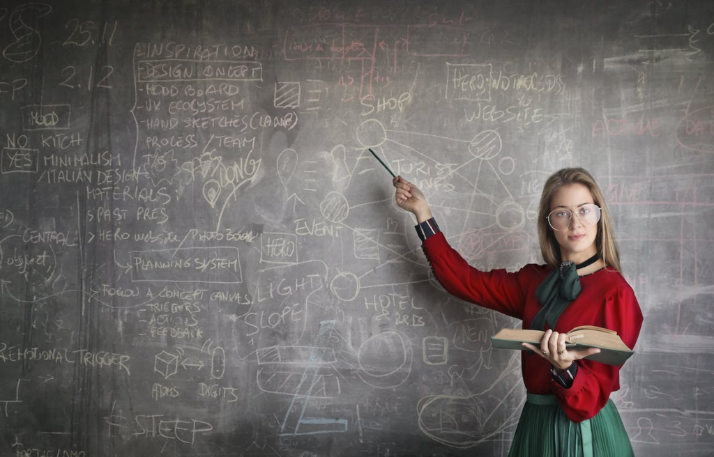 mathematics teacher holding a stick and a book