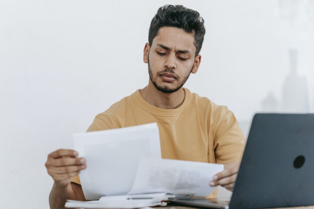 Epistemology graduate looking through documents at workplace