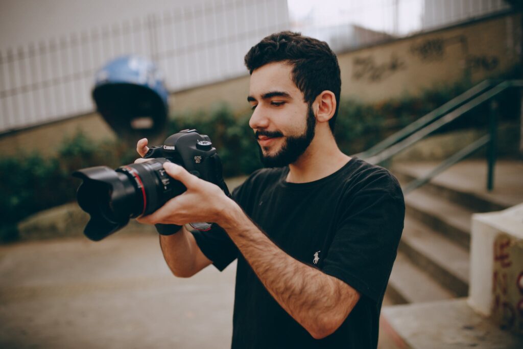 Photo of Man Taking Photo Using a Dslr Camera