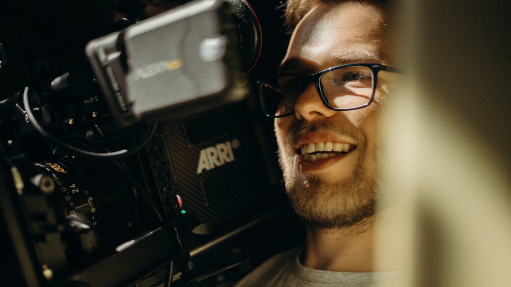 Smiling Man Carrying Camera