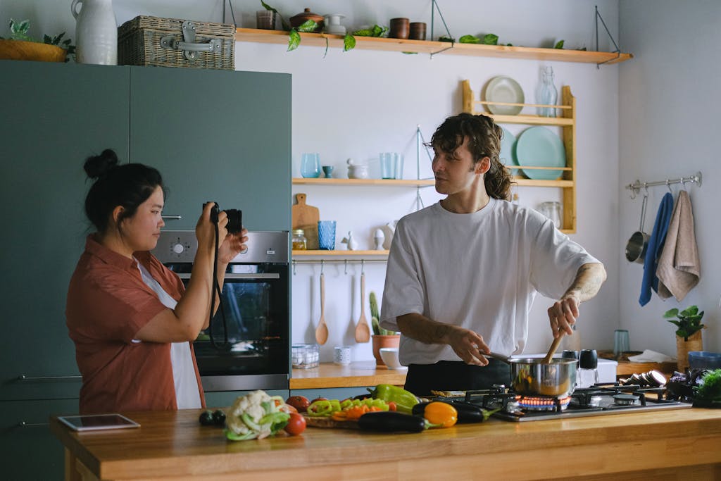 Woman Recording a Man Cooking 