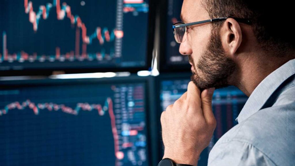 a man looking at trading charts